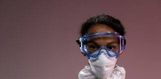Portrait of a healthcare worker wearing protective gear including goggles and mask.