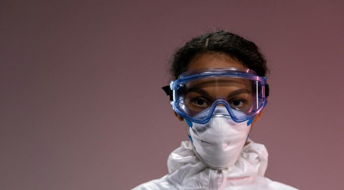 Portrait of a healthcare worker wearing protective gear including goggles and mask.