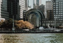 Elegant cityscape featuring modern waterfront buildings and a marina in an urban setting.