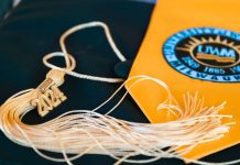 Close-up of a graduation cap featuring a 2024 tassel and a university emblem, symbolizing academic achievement.