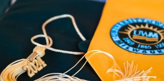 Close-up of a graduation cap featuring a 2024 tassel and a university emblem, symbolizing academic achievement.