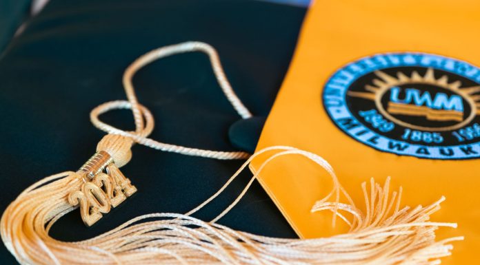 Close-up of a graduation cap featuring a 2024 tassel and a university emblem, symbolizing academic achievement.