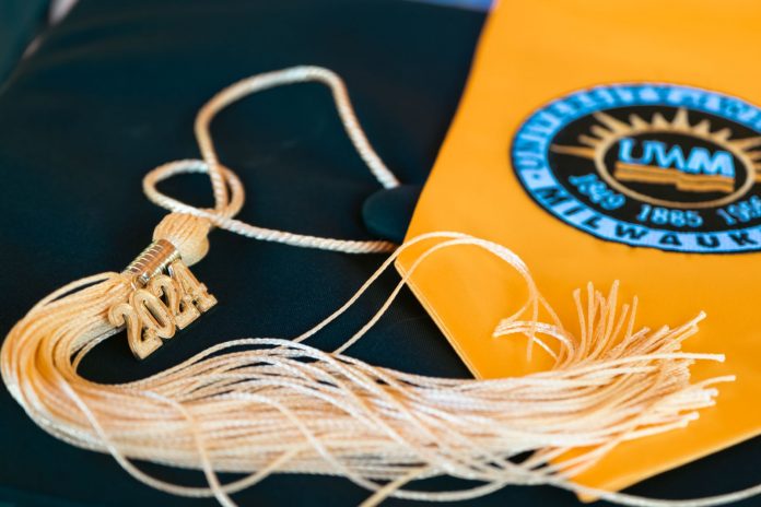 Close-up of a graduation cap featuring a 2024 tassel and a university emblem, symbolizing academic achievement.