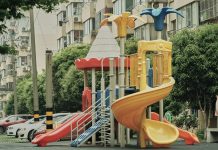 Best Areas to Raise a Family in Jersey City in 2026 Vibrant playground with slides and equipment in an urban park setting surrounded by apartment buildings.