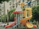 Best Areas to Raise a Family in Jersey City in 2026 Vibrant playground with slides and equipment in an urban park setting surrounded by apartment buildings.