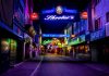 Explore the vibrant neon-lit streets of Hamburg's famous Reeperbahn district at night.