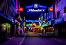 Explore the vibrant neon-lit streets of Hamburg's famous Reeperbahn district at night.