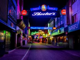 Explore the vibrant neon-lit streets of Hamburg's famous Reeperbahn district at night.