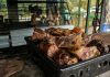 A close-up of a fresh, rustic barbecue platter filled with various grilled meats, perfect for outdoor gatherings.