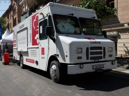 Best Food Trucks in Bayonne: A 2026 Local’s Guide to Top Spots White food truck by LiveChef at a bustling street festival under sunny skies.