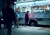 Vibrant urban scene of people enjoying a food truck at night in New York City.