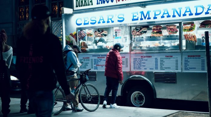 Vibrant urban scene of people enjoying a food truck at night in New York City.