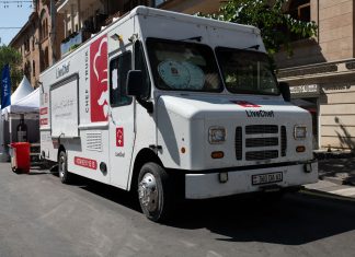 Best Food Trucks in Union City: A Local’s Guide to Mobile Eats in 2026 White food truck by LiveChef at a bustling street festival under sunny skies.