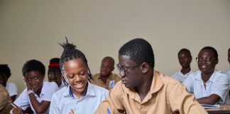 High school students collaborating during a lesson in a classroom environment.