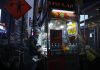 Urban street food vendor serving at night in New York City, capturing the bustling nightlife.