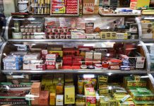 A nostalgic view of vintage pharmacy products displayed in a retro shop setting.