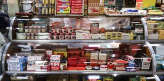 A nostalgic view of vintage pharmacy products displayed in a retro shop setting.