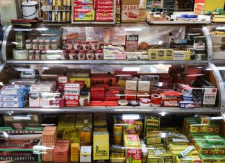 A nostalgic view of vintage pharmacy products displayed in a retro shop setting.
