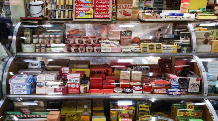 A nostalgic view of vintage pharmacy products displayed in a retro shop setting.