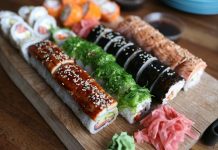Best Sushi in West New York (2026 Guide): Top Spots for Fresh Rolls & Sashimi A delicious selection of sushi rolls with toppings like seaweed and sesame seeds on a wooden platter.