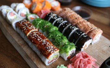 Best Sushi in West New York (2026 Guide): Top Spots for Fresh Rolls & Sashimi A delicious selection of sushi rolls with toppings like seaweed and sesame seeds on a wooden platter.
