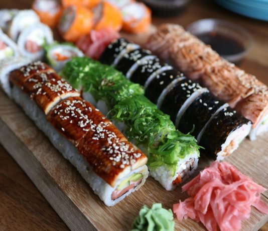 Best Sushi in West New York (2026 Guide): Top Spots for Fresh Rolls & Sashimi A delicious selection of sushi rolls with toppings like seaweed and sesame seeds on a wooden platter.
