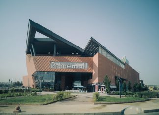Exterior of modern Prime Mall shopping center in urban Turkey, showcasing architectural design.