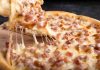 BREAKING: Best Hoboken Pizza Spots Ranked by Craving Close-up of a delicious pepperoni pizza slice with gooey mozzarella cheese.