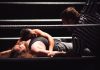 Intense wrestling match showcasing a dramatic pinfall with referee counting.