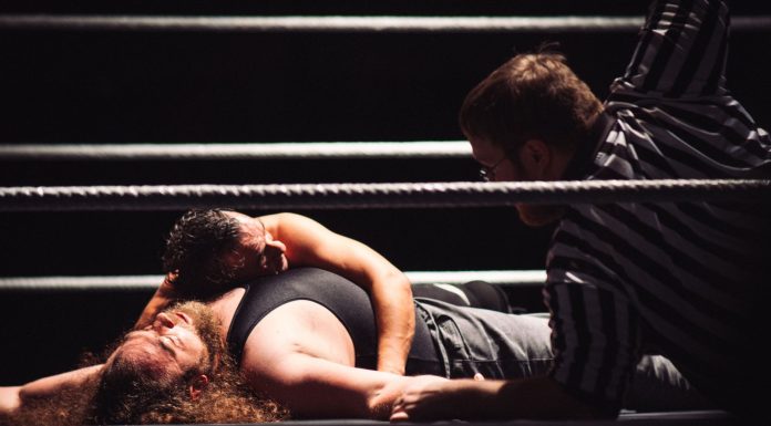 BREAKING: Brawl Erupts at Jersey City Schools Union Party Intense wrestling match showcasing a dramatic pinfall with referee counting.