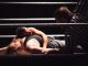 Intense wrestling match showcasing a dramatic pinfall with referee counting.