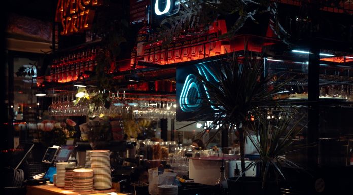 Warm lit bar scene in Katowice, showcasing Aperol decor and cozy atmosphere at night.