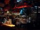 BREAKING: Café at Journal Squared Launches After-Hours Menu Warm lit bar scene in Katowice, showcasing Aperol decor and cozy atmosphere at night.