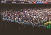 A vibrant crowd fills a football stadium during a lively match.