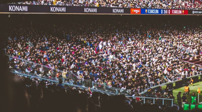 A vibrant crowd fills a football stadium during a lively match.