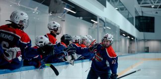 BREAKING: Hoboken Rockets Win Three Championships in One Season Ice hockey team players celebrating during a game in an indoor rink.