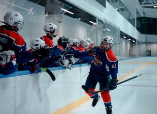 BREAKING: Hoboken Rockets Win Three Championships in One Season Ice hockey team players celebrating during a game in an indoor rink.