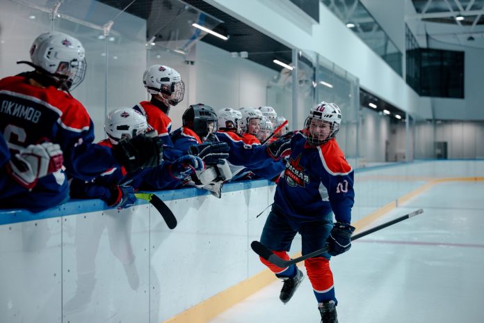 breaking-hoboken-rockets-win-three-championships-i Ice hockey team players celebrating during a game in an indoor rink.