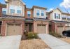 Charming row of modern townhouses featuring brick facades and attached garages.