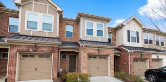 Charming row of modern townhouses featuring brick facades and attached garages.