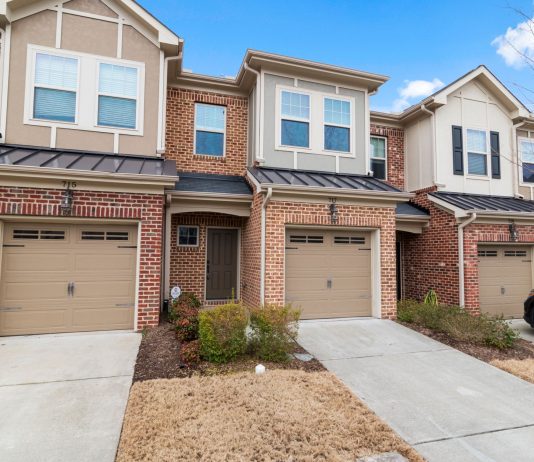 Charming row of modern townhouses featuring brick facades and attached garages.