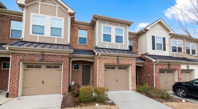 Charming row of modern townhouses featuring brick facades and attached garages.