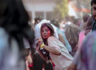 BREAKING: Jersey City Hosts Color Festival, Night Market This Weekend Vibrant Holi festival scene with people celebrating with colorful powders outdoors.
