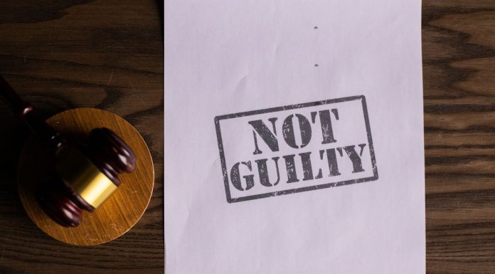 BREAKING: Man Guilty of Murdering Former Rutgers Athlete in Hoboken A courtroom document labeled 'Not Guilty' beside a gavel symbolizes justice.