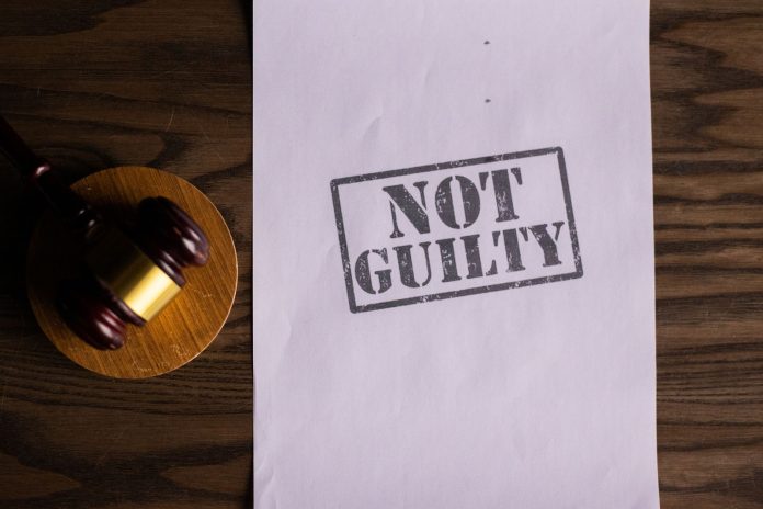 breaking-man-guilty-of-murdering-former-rutgers-at A courtroom document labeled 'Not Guilty' beside a gavel symbolizes justice.