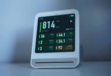 A sleek air quality monitor showing CO2 and other air metrics, ideal for smart homes.