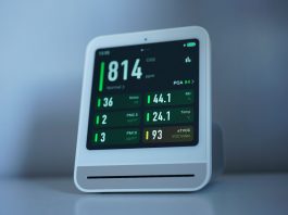 A sleek air quality monitor showing CO2 and other air metrics, ideal for smart homes.