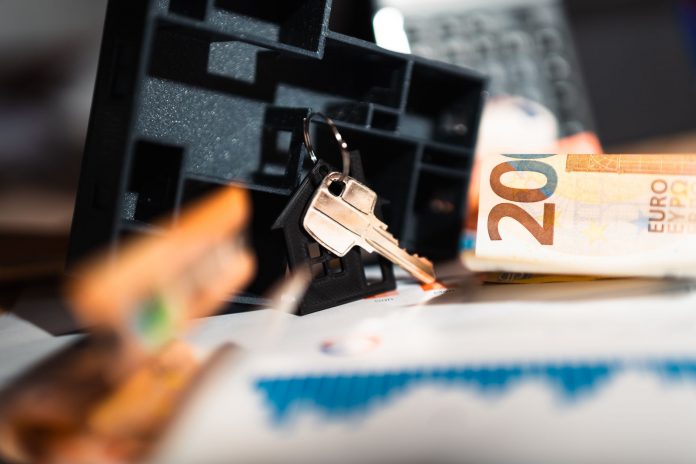 breaking-new-management-chosen-for-6-000-unit-jers Keys with a house model, Euro bills, and charts suggesting real estate and financial themes.