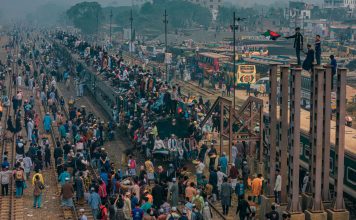 BREAKING: NJ Transit Manages World Cup Crowds, $98 Fare Draws Criticism A bustling scene at a train station in Dhaka, Bangladesh with people crowding trains and platforms.