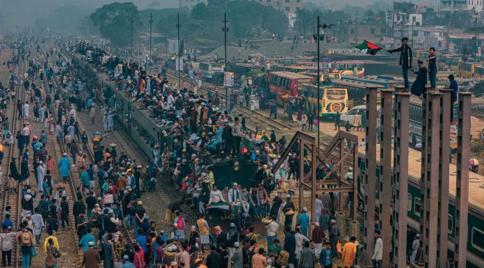 BREAKING: NJ Transit Manages World Cup Crowds, $98 Fare Draws Criticism A bustling scene at a train station in Dhaka, Bangladesh with people crowding trains and platforms.
